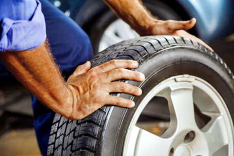 A man rolling a tire